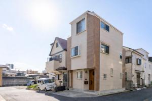 a building with a van parked in front of it at The Ichikawa House in Ichikawa
