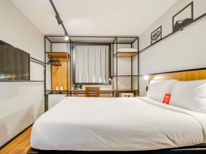 a bedroom with a large white bed and a desk at ibis Copacabana Posto 2 in Rio de Janeiro +93 photos