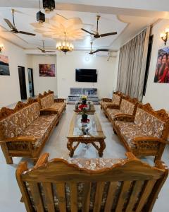 a large living room with couches and a table at Thano Retreat in Dehradun