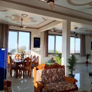 a living room with a table and chairs and a couch at Thano Retreat in Dehradun