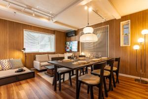 a dining room and living room with a table and chairs at The Ichikawa House in Ichikawa