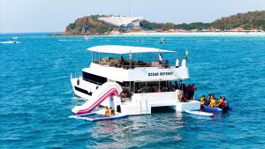 a ferry boat with a slide in the water at Ocean Odyssey in Na Jomtien