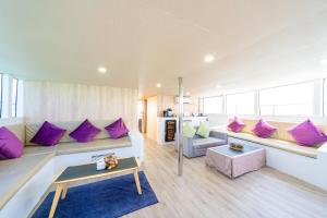 a living room with purple pillows on a couch at Ocean Odyssey in Na Jomtien
