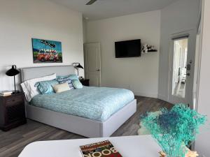 a bedroom with a bed and a flat screen tv at Lakeview Bed and Breakfast in Kelowna