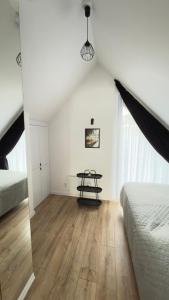 a bedroom with a table in the corner of a room at Sosina Dreams in Jaworzno