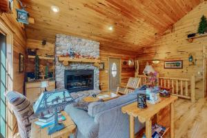 a living room with a fireplace in a log cabin at Ridge Wood in Empire