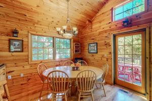 a dining room with a table and chairs at Ridge Wood in Empire