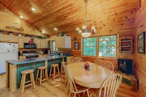 a kitchen with a table and chairs in a cabin at Ridge Wood in Empire