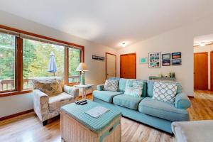 a living room with a blue couch and a chair at Dunes Trail in Glen Arbor