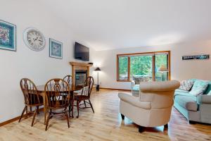 a living room with a table and a couch at Dunes Trail in Glen Arbor