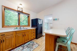 a kitchen with a sink and a refrigerator at Dunes Trail in Glen Arbor +13 photos