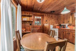 a wooden kitchen with a wooden table and chairs at Cottage Living in Beulah