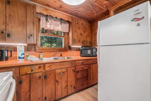 a kitchen with a white refrigerator and a sink at Cottage Living in Beulah +24 photos