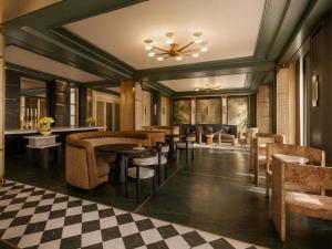 a restaurant with tables and chairs and a checkered floor at FAIRMONT NEW ORLEANS in New Orleans