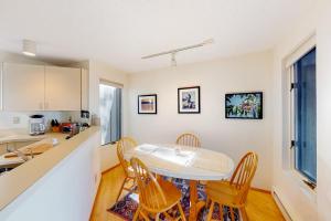 a kitchen and dining room with a table and chairs at Hawks Nest 58 in Glen Arbor