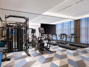 a gym with treadmills and elliptical machines at Novotel Changshu Yushan in Changshu