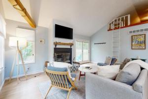 a living room with a couch and a fireplace at Livywood Cottage in New Buffalo