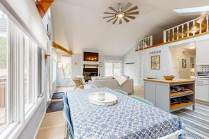 a kitchen and living room with a table in a room at Livywood Cottage in New Buffalo +17 photos