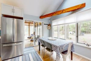 a kitchen with a table and a refrigerator at Livywood Cottage in New Buffalo