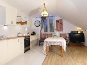 a kitchen with a table with a table cloth on it at Agroturystyka pod Czarną Sosną in Biały Ług