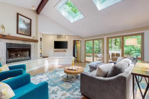 a living room with couches and a fireplace at The Tree House in New Buffalo