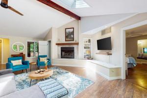 a large living room with a couch and a tv at The Tree House in New Buffalo