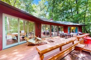 a large screened in porch of a home with a wooden deck at The Tree House in New Buffalo
