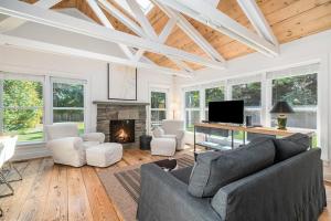 a living room with a couch and a fireplace at White Pines Cottage in Glen Arbor