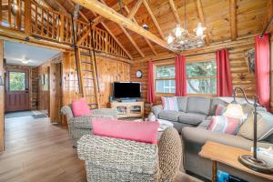 a living room with a couch and a tv at Cedar Crest in Empire