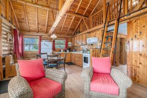 a living room with two chairs and a kitchen at Cedar Crest in Empire