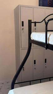 a bunk bed with lockers in a room at Emtri Apartments in Sipak