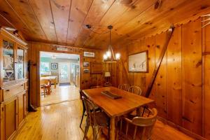 a wooden dining room with a wooden table and chairs at Empire Lodge in Empire