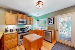 a kitchen with wooden cabinets and a stove top oven at Empire Lodge in Empire +18 photos