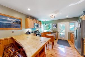 a kitchen with a wooden table and a refrigerator at Empire Lodge in Empire