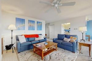 a living room with two blue couches and a table at South Beach 43 in Glen Arbor