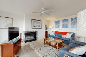 a living room with a blue couch and a fireplace at South Beach 43 in Glen Arbor
