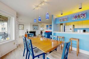 a dining room and kitchen with a table and chairs at South Beach 43 in Glen Arbor +18 photos