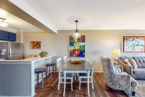 a kitchen and living room with a table and chairs at Ship Watch 15 in Glen Arbor