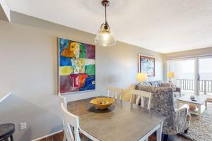 a living room with a table and a couch at Ship Watch 15 in Glen Arbor