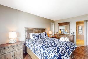 a bedroom with a bed with a blue and white comforter at Ship Watch 15 in Glen Arbor +13 photos
