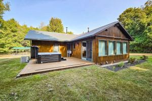 a wooden house with a deck in a yard at Trout Lily Cabin in Beulah +27 photos