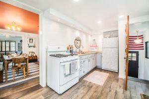a kitchen with white appliances and a dining room at The Bright Side in Union Pier +16 photos