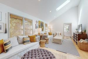 a living room with a white couch and a table at Lilly Bell Villa in Three Oaks