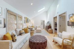 a living room with a white couch and a table at Lilly Bell Villa in Three Oaks