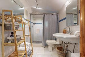 a bathroom with a bunk bed and a toilet and a sink at Lilly Bell Villa in Three Oaks
