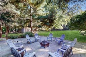 a group of chairs and tables on a patio at Lilly Bell Villa in Three Oaks