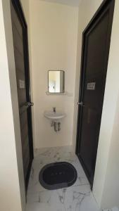 a bathroom with a sink and a toilet and a mirror at Emtri Apartments in Sipak +30 photos