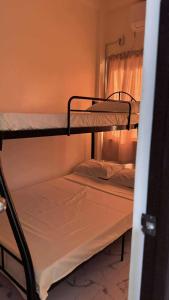 two bunk beds in a room with a window at Emtri Apartments in Sipak