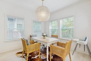 a dining room with a table and chairs and a chandelier at Wrightwood Cottage in South Haven