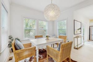 a dining room with a white table and chairs at Wrightwood Cottage in South Haven